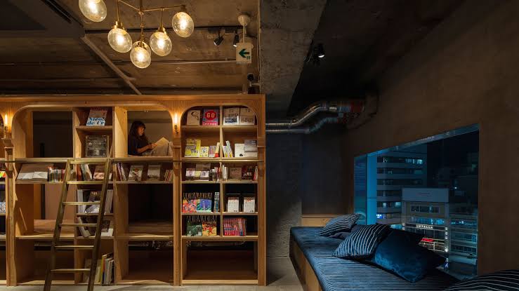 Sleeping compartments built into a wall of stocked bookshelves