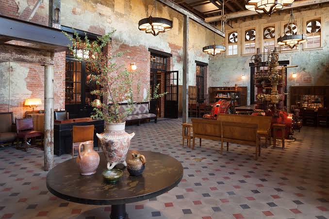Brick brewhouse converted to a hotel with tall arched windows