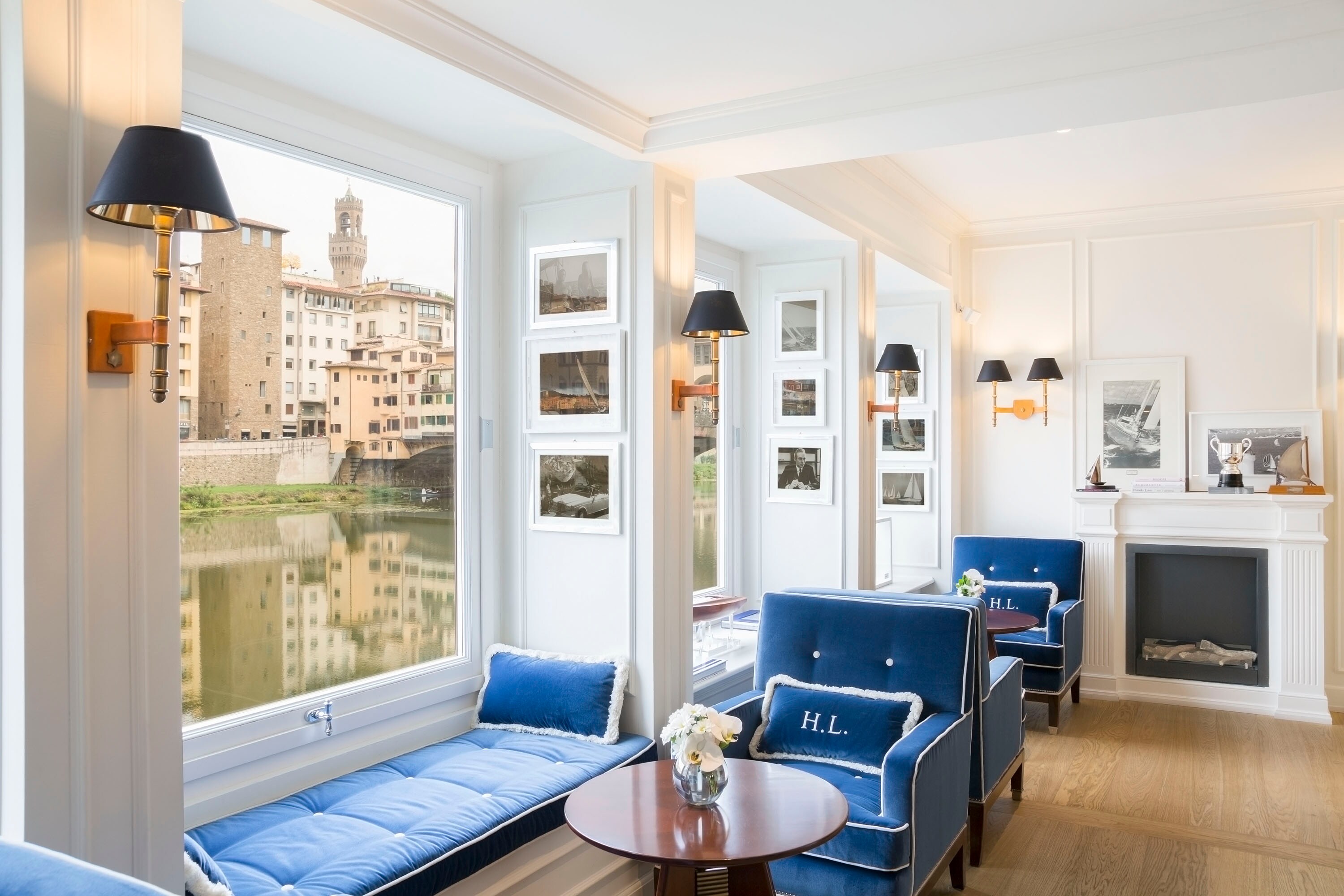 Hotel facade on a river quay with shuttered windows above the water